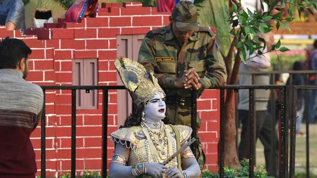 An artist dressed as lord Krishna talks to an army Jawan during the festival. The event is open to the public and entry is free. However, identity proof is necessary for entry. (Raj K Raj/HT PHOTO)