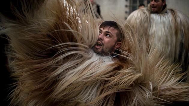Dancers, known as Kukeri, perform on Sunday during the International Festival of the Masquerade Games in Pernik, near the capital Sofia. (AFP) Dancers, known as Kukeri, perform on Sunday during the International Festival of the Masquerade Games in Pernik, near the capital Sofia. (AFP)