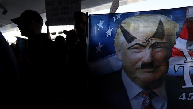 A protester holds a flag during a demonstration against the immigration ban that was imposed by US President Donald Trump at Los Angeles International Airport in Los Angeles, California. (Justin Sullivan/AFP) A protester holds a flag during a demonstration against the immigration ban that was imposed by US President Donald Trump at Los Angeles International Airport in Los Angeles, California. (Justin Sullivan/AFP)