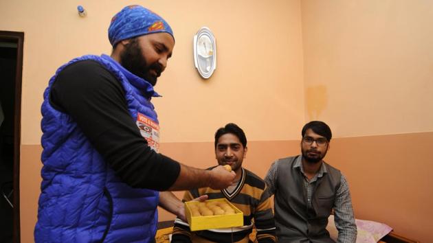 Manveer's brother Sachin (right), cousin Neeraj Gurjar (centre) and friend Ravindra Bharadwaj (left) celebrate his victory.(Sunil Ghosh/HT Photo)