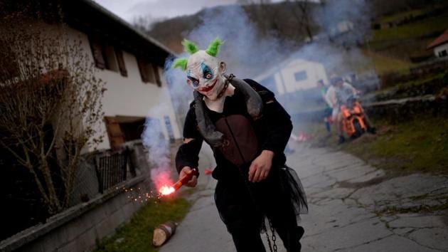 A masked reveller holds a flare during celebrations in Ituren. (Reuters photo) A masked reveller holds a flare during celebrations in Ituren. (Reuters photo)