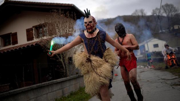 A masked reveller holds a flare during carnival celebrations in Ituren. (Reuters photo) A masked reveller holds a flare during carnival celebrations in Ituren. (Reuters photo)