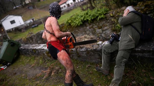 A masked reveller carries a chainless chainsaw during carnival celebrations in Ituren. (Reuters photo) A masked reveller carries a chainless chainsaw during carnival celebrations in Ituren. (Reuters photo)