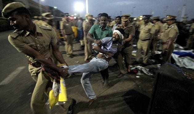 A protestor supporting Jallikattu tries to resist as police remove them from Chennai’s Marina beach on January 23. (AP File) A protestor supporting Jallikattu tries to resist as police remove them from Chennai’s Marina beach on January 23. (AP File)