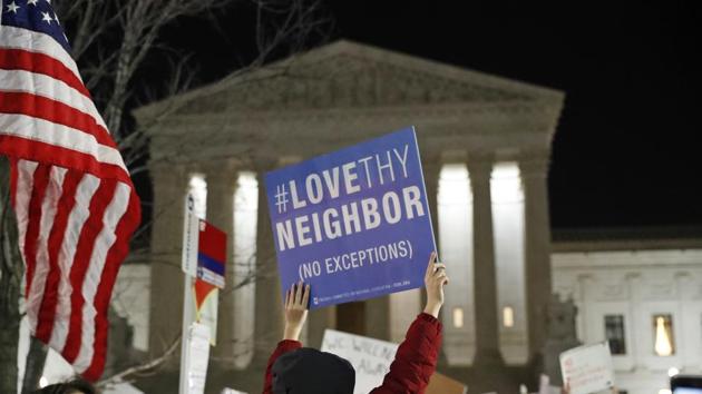 A protester carries a sign in front of the Supreme Court during a protest about President Donald Trump's recent executive orders, Monday, Jan. 30, 2017 in Washington. (AP Photo/Alex Brandon) (AP) A protester carries a sign in front of the Supreme Court during a protest about President Donald Trump's recent executive orders, Monday, Jan. 30, 2017 in Washington. (AP Photo/Alex Brandon) (AP)
