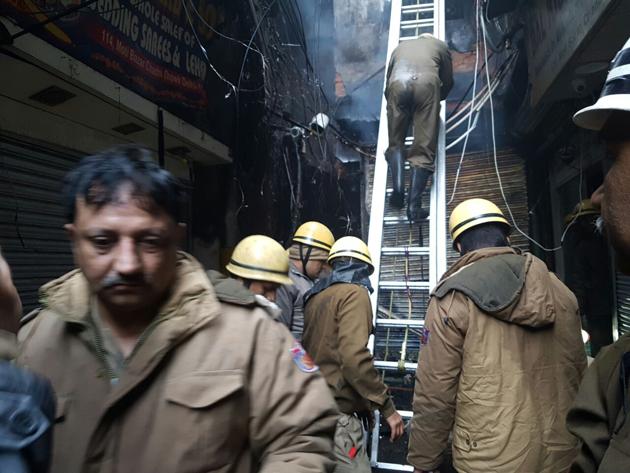 Firemen at Moti Bazar in Chandni Chowk where at least 15 shops were gutted in an early morning blaze on Wednesday. (Handout) Firemen at Moti Bazar in Chandni Chowk where at least 15 shops were gutted in an early morning blaze on Wednesday. (Handout)