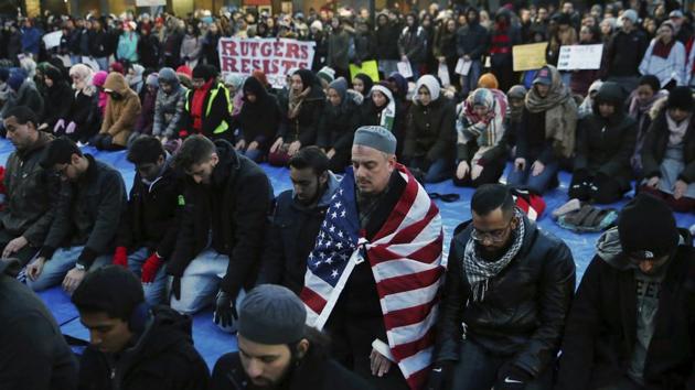 Students of Rutgers University in New Brunswick, New Jersey, gather for prayers during a rally on Tuesday to express discontent with President Donald Trump's executive order.(AP) Students of Rutgers University in New Brunswick, New Jersey, gather for prayers during a rally on Tuesday to express discontent with President Donald Trump's executive order.(AP)