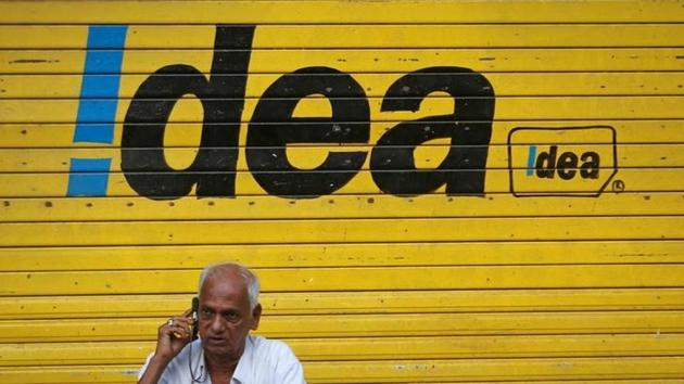 A man speaks on his mobile phone as he sits in front of a shop displaying the Idea Cellular Ltd's logo on its shutter in Mumbai. (Reuters Photo) A man speaks on his mobile phone as he sits in front of a shop displaying the Idea Cellular Ltd's logo on its shutter in Mumbai. (Reuters Photo)