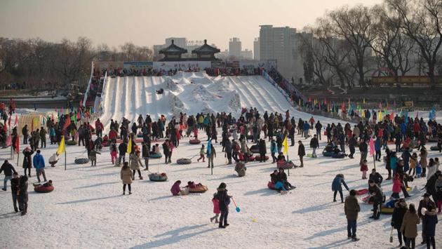 People enjoy playing with snow at a Spring Festival fair in Beijing. The origins of the festival are traced back to the Shang Dynasty when people offered sacrifices to gods and ancestors to ring in the new year. (Nicolas ASFOURI / AFP)