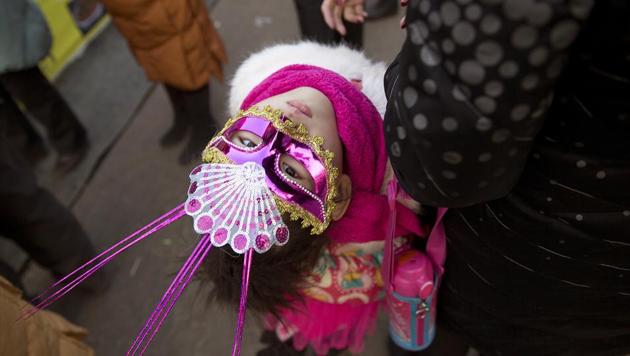 A child wears a carnival mask during a visit to a Spring Festival carnival in Beijing, China, on January 31, 2017. Residents are enjoying a week long holiday for the Chinese New Year and visiting various temple fairs and carnivals around the Chinese capital. (Ng Han Guan / AP)