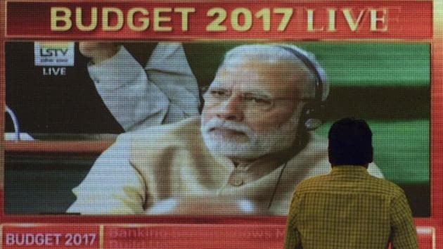An Indian office-worker walks past a digital screen showing Indian Prime Minister Narendra Modi during finance minister Arun Jaitley delivering the budget speech at Parliament at the Bombay Stock Exchange (BSE) in Mumbai.(AFP Photo) An Indian office-worker walks past a digital screen showing Indian Prime Minister Narendra Modi during finance minister Arun Jaitley delivering the budget speech at Parliament at the Bombay Stock Exchange (BSE) in Mumbai.(AFP Photo)