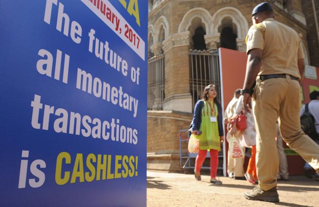 Visitors walk past a sign for a digital or cashless economy at a Digital Wealth Fair promoting e-payments in Mumbai.(AFP)