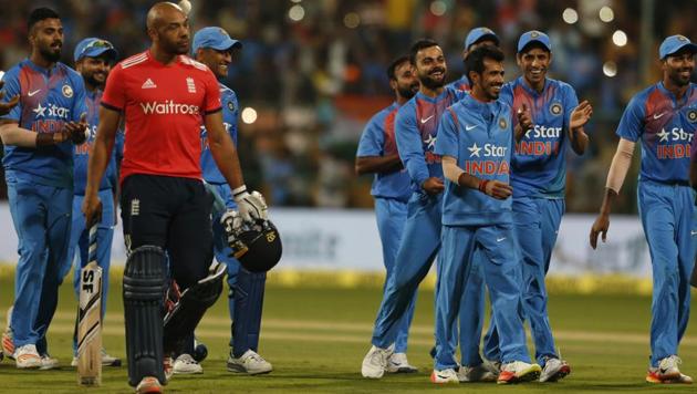 Indian cricketers celebrate their victory over England in their third Twenty20 international cricket match at Chinnaswamy Stadium. (AP)