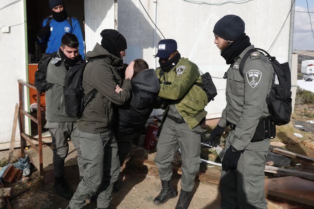 Israeli settlers scuffle with security forces at the Amona outpost on Wednesday as they evict the hardline occupants of the wildcat settlement outpost in line with a court ruling that determined the homes were built on private Palestinian land.(AFP) Israeli settlers scuffle with security forces at the Amona outpost on Wednesday as they evict the hardline occupants of the wildcat settlement outpost in line with a court ruling that determined the homes were built on private Palestinian land.(AFP)