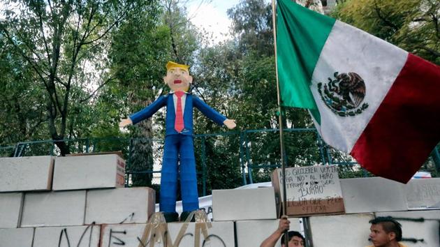 People protest against US President Donald Trump's inauguration next to a fake wall with a Mexican national flag and a dummy representing him in Mexico City. (AFP Photo) People protest against US President Donald Trump's inauguration next to a fake wall with a Mexican national flag and a dummy representing him in Mexico City. (AFP Photo)