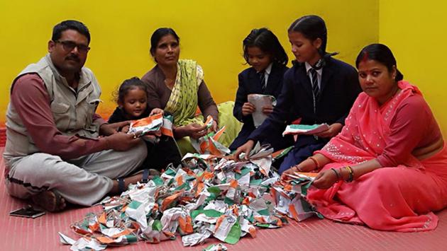 Businessman Anil Choudhary sits with his family sifting the tricolour. (Aditya Nath Jha/HT photo) Businessman Anil Choudhary sits with his family sifting the tricolour. (Aditya Nath Jha/HT photo)