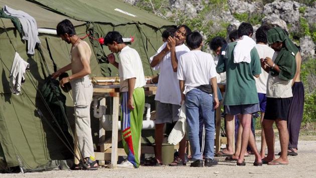 In this Sept. 21, 2001, file photo, men shave, brush their teeth and prepare for the day at a refugee camp on the Island of Nauru. Australia's Prime Minister Malcolm Turnbull insisted Thursday, Feb. 2, 2017, that a deal struck with the Obama administration that would allow mostly Muslim refugees rejected by Australia to be resettled in the United States was still on, despite President Donald Trump dubbing the agreement "dumb" and vowing to review it.(AP)