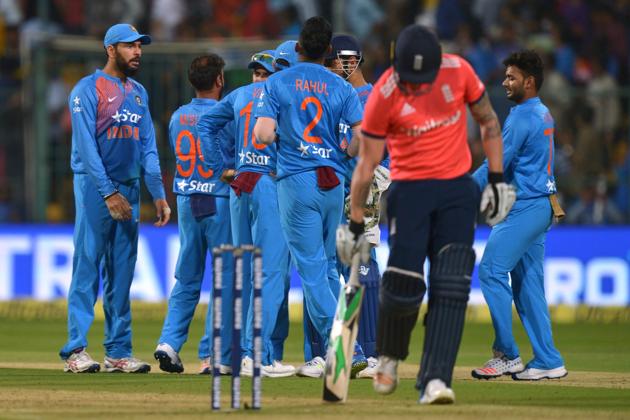 Indian players celebrate the dismissal of England batsman Jason Roy during the third T20 match at the Chinnaswamy Stadium in Bangalore on Wednesday. England lost by 75 runs to lose the three-match series 2-1.(AFP)