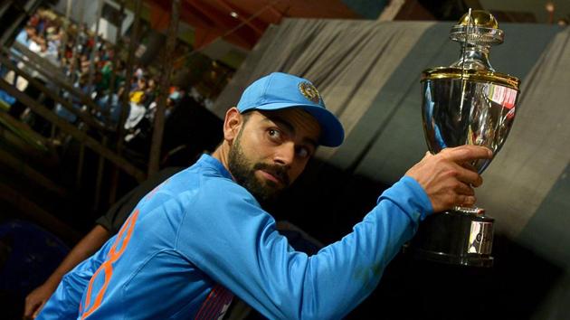 Virat Kohli displays the winners trophy after India beat England in the third T20 international at the Chinnaswamy Stadium in Bangalore on Wednesday to clinch the series 2-1.(AFP)