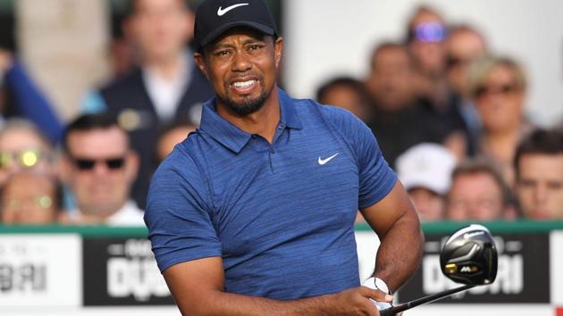 Tiger Woods reacts after playing a shot during the Dubai Desert Classic at the Emirates Golf Club in Dubai on Thursday. (AFP) Tiger Woods reacts after playing a shot during the Dubai Desert Classic at the Emirates Golf Club in Dubai on Thursday. (AFP)