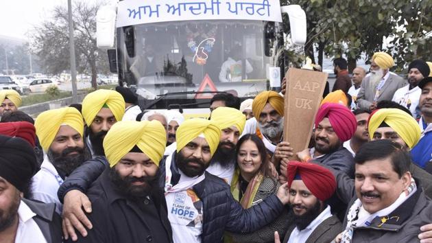 AAP senior leader Sanjay Singh, Punjab convener Gurpreet Ghuggi and Himmat Singh Shergill holding flame of hope brought by NRIs from UK, who landed at Sri Guru Ramdas Jee Amritsar Airport. (Gurpreet Singh / HT PHOTO)