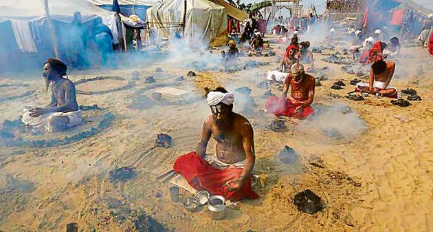 Mahatyagees performing Dhuni Puja in Magh Mela area. (AP) Mahatyagees performing Dhuni Puja in Magh Mela area. (AP)