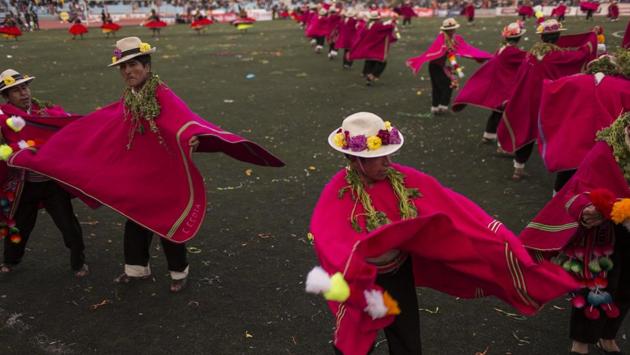 Dancers perform during Virgin of Candelaria celebrations in Puno, Peru. Some dances gesture toward everyday village activities such as grazing llamas or shearing animals. Others depict the Spanish conquest or the conscription of villagers as soldiers. (Rodrigo Abd / AP)