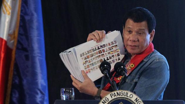 Philippine President Rodrigo Duterte holds a compilation of pictures of people involved in drugs, as he speaks during a meeting in Davao city in southern Philippines on Thursday. (Reuters photo) Philippine President Rodrigo Duterte holds a compilation of pictures of people involved in drugs, as he speaks during a meeting in Davao city in southern Philippines on Thursday. (Reuters photo)