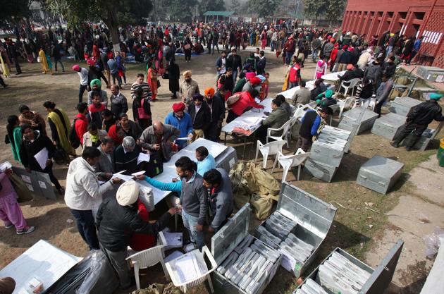 Polling officials collect electronic voting machines (EVM) at a distribution centre in Dera Bassi in Punjab on Friday on the eve of the state assembly elections.