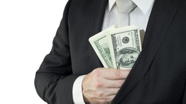 As the medical director and an agent of the company, the accused corruptly solicited and accepted cash payments of $2,500 and $7,500.(Shutterstock) As the medical director and an agent of the company, the accused corruptly solicited and accepted cash payments of $2,500 and $7,500.(Shutterstock)