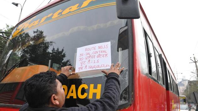 A bus driver getting ready to carry poll staff to their destinations ahead of assembly elections in Jalandhar. (Pardeep Pandit/HT )