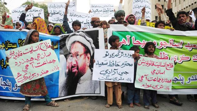 Demonstrators hold placards and banners during a protest after Jamaat-ud-Dawa (JuD) organisation leader Hafiz Saeed was placed under house arrest in Karachi. (AFP Photo) Demonstrators hold placards and banners during a protest after Jamaat-ud-Dawa (JuD) organisation leader Hafiz Saeed was placed under house arrest in Karachi. (AFP Photo)