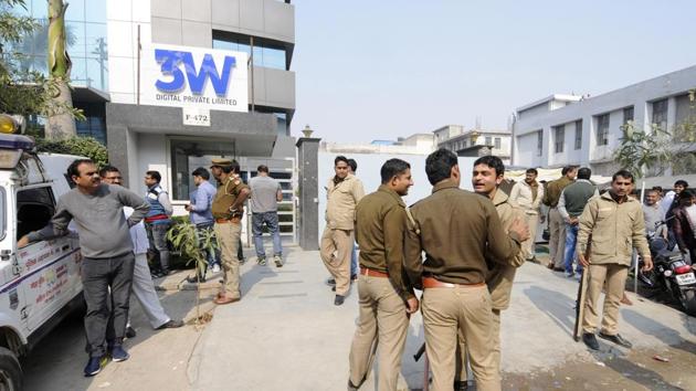 Noida: Police outside the office of Ablaze Info Solutions Limited in Noida Sector 63 on Friday. Investors in the firm had gathered outside the company to both protest and support it.(Sunil Ghosh/HT Photo)