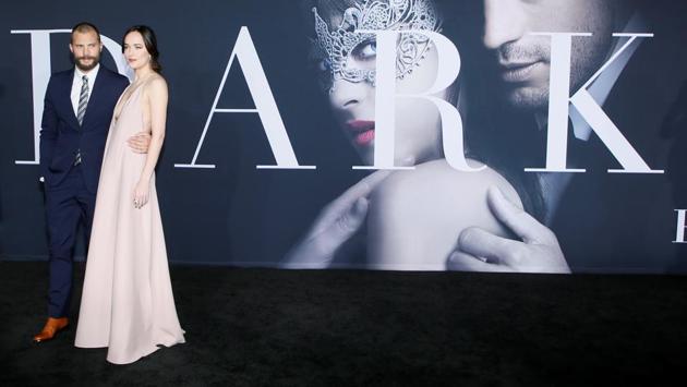 Jamie Dornan (L) and Dakota Johnson pose at the premiere of the film Fifty Shades Darker. Johnson and Dornan play lovers Anastasia Steele and Christian Grey. (REUTERS)