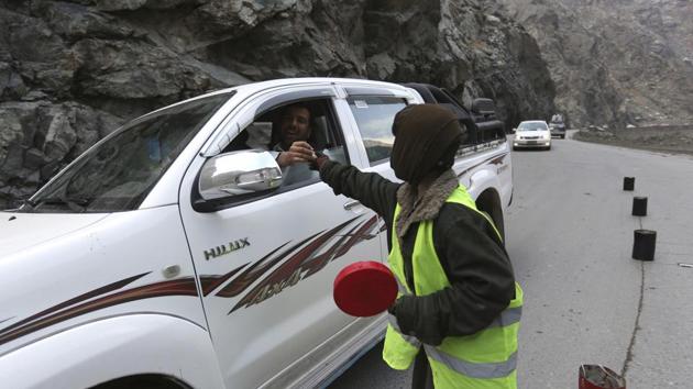 11-year-old Sedaqat receives a tip from a motorist on the Maipur Pass, along the main highway from Kabul to Pakistan, near Kabul, Afghanistan. (AP) 11-year-old Sedaqat receives a tip from a motorist on the Maipur Pass, along the main highway from Kabul to Pakistan, near Kabul, Afghanistan. (AP)