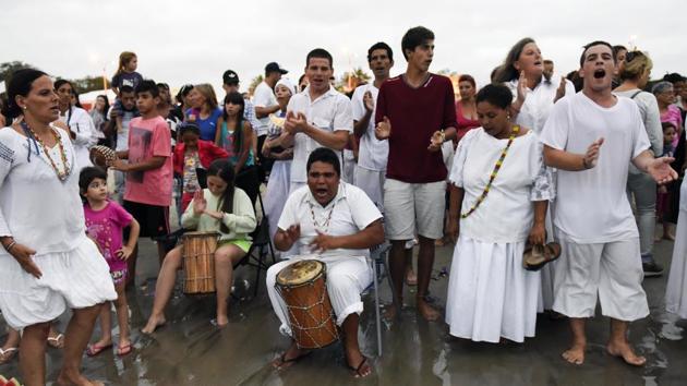 Worshippers sing to honor the African sea goddess Yemanja, at the sea shore in Montevideo, Uruguay, Thursday, Feb. 2, 2017. (Matilde Campodonico / AP)