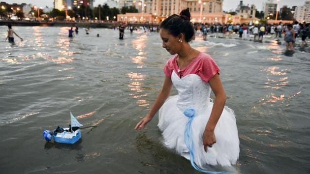 A woman releases a small boat as an offering for the African sea goddess Yemanja, at a beach in Montevideo, Uruguay, Thursday, Feb. 2, 2017. Thousands of worshippers come to the beach on Yemanja's feast day, bearing candles, flowers, perfumes and fruit to show their gratitude for her blessings. (Matilde Campodonico / AP)