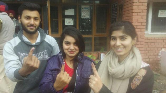 First time voters pose outside polling booth in Mohali on Saturday. (Keshav Singh/HT Photo)
