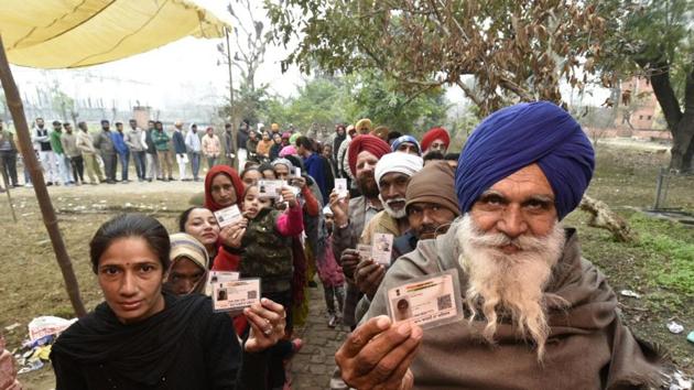 Villagers show their voter identity cards before voting at Majitha constituency polling station Amritsar, Punjab. (Gurpreet Singh/HT Photo)