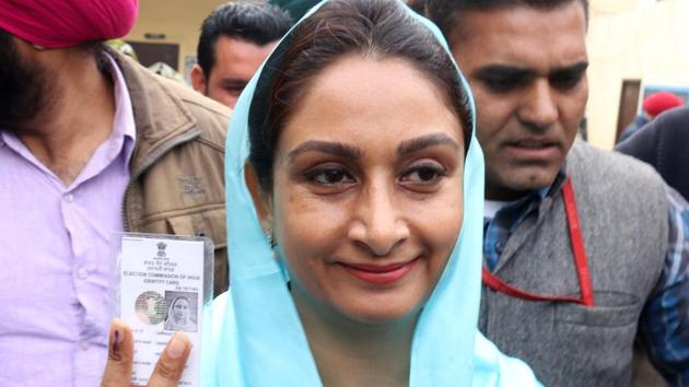 Union minister Harsimrat Kaur Badal showing her voter card outside polling booth in Badal village on Saturday. (Sanjeev Kumar/HT photo)