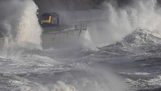 Waves hit a train during heavy seas and high winds in Dawlish in south west Britain, on February 2, 2017. (Toby Melville / REUTERS)
