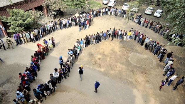A serpentine queue of voters waiting for their turn to cast vote at a polling station in Mohali on Saturday.(Ravi Kumar/HT)
