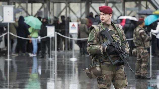A French soldier patrols in the courtyard of the Louvre museum with the visitor control in background in Paris.(AP) A French soldier patrols in the courtyard of the Louvre museum with the visitor control in background in Paris.(AP)