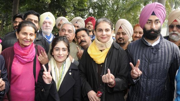 MLA Preneet Kaur with her family members after casting vote at Government College for Women in Patiala on Saturday. (Bharat Bhushan/HT Photo )