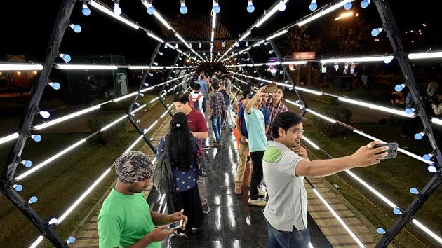 People take selfies against an installation. (Arijit Sen/HT PHOTO)