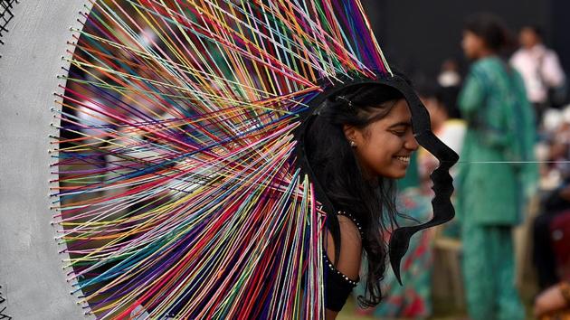 A visitor poses with an installation at Cross Maidan. (Arijit Sen/HT PHOTO)