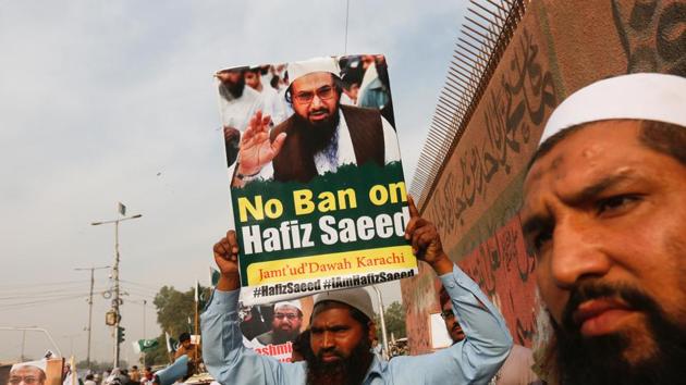 A supporter of Jamaat-ud-Dawa (JuD), carries a sign with others as they listen the speech of leaders (unseen) to condemn the house arrest of Hafiz Muhammad Saeed, chief of (JuD), during a protest demonstration in Karachi, Pakistan.(Reuters Photo) A supporter of Jamaat-ud-Dawa (JuD), carries a sign with others as they listen the speech of leaders (unseen) to condemn the house arrest of Hafiz Muhammad Saeed, chief of (JuD), during a protest demonstration in Karachi, Pakistan.(Reuters Photo)