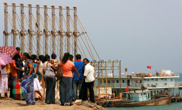 People watch Chinese dredging ships work at Hambantota.(Reuters File) People watch Chinese dredging ships work at Hambantota.(Reuters File)