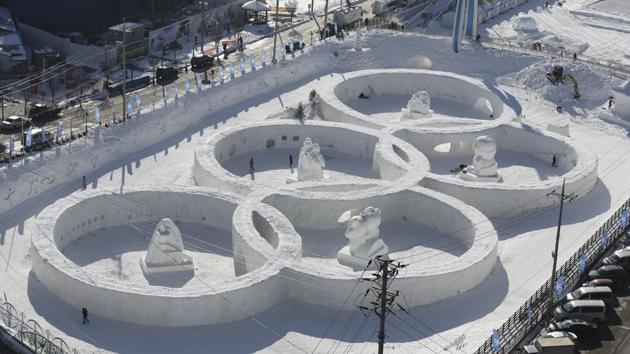 Visitors tour near the snow sculpture in the shape of the Olympic rings displayed at the Daegwanryung Snow festival in Pyeongchang, South Korea. South Korea's Pyeongchang is the host city of the 2018 Olympic and Paralympic Winter Games. (Lee Jin-man / AP)