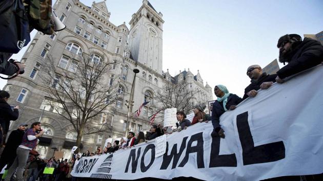 People march along Pennsylvania Avenue past the Trump International Hotel during a rally protesting the immigration policies of President Donald Trump, near the White House in Washington on Saturday. (AP photo) People march along Pennsylvania Avenue past the Trump International Hotel during a rally protesting the immigration policies of President Donald Trump, near the White House in Washington on Saturday. (AP photo)